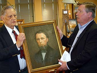 Stewartville painter Charles Pearson, left, and Mayor Chuck Murphy unveil Pearson's portrait of Stewartville founder Charles Stewart. The unveiling took place at a reception at First Farmers&Merchants State Bank in March. 