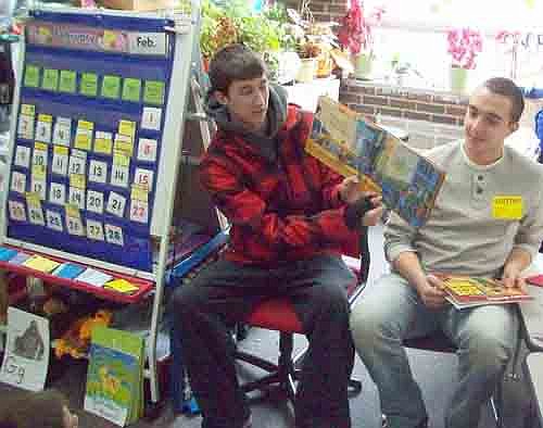 The Stewartville varsity boys basketball team made its annual visit to Bonner Elementary School's K-3 classes to read to students as part of "I Love to Read Month." Here, Dain Bauman and Conner Hanf read to a group of students.