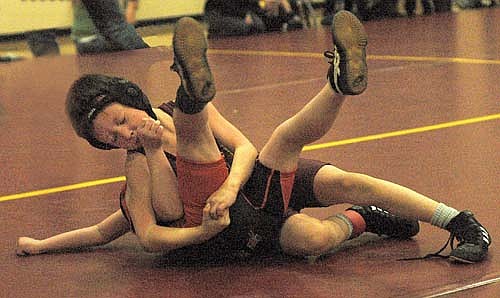 Stewartville kindergartener Brayden Stier rocks back, collecting back points on his 55-pound opponent during action at the Tiger Open, a district qualifier on March 15.