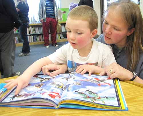 Diane Johnson of Stewartville reads "The Lego Adventure Book" to her son Dale, 4 1/2, at the Wee Care Pajama Night at the Stewartville Public Library on Thursday evening, March 13. Dale is a student at Wee Care.