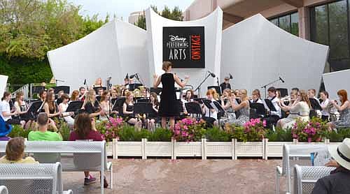 Jessica Honsey directs the Stewartville High School Symphonic Band at Melody Gardens at Innoventions West in EPCOT at the Walt Disney World Resort in Florida last week. Josh Wilson, a senior trumpet player, enjoyed the band's trip. "I'll never forget it,"&#8200;he said.
