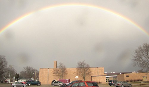 A rainbow arched across the sky above Stewartville Middle School on Monday, March 31. The dark spots are raindrops on the camera lens.