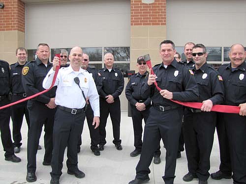The Stewartville Fire Department hosted an open house to welcome the public to its brand new Fire Station this past Saturday, April 26. In lieu the traditional ribbon-cutting ceremony, Vance Swisher, fire chief, in white shirt at left, and Larry Mueller, assistant fire chief, third from right in the front row, disconnected a fire hose coupling to celebrate the official opening of the $1.8 million Fire Hall. "This building is a blessing," Swisher said.