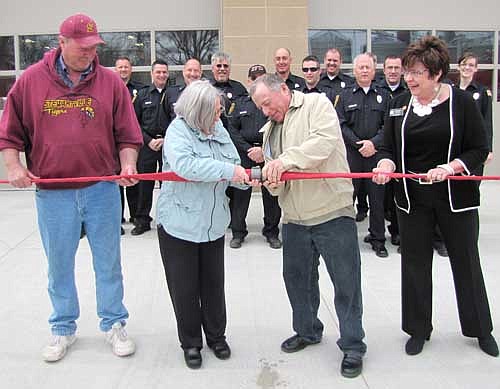 Just as it took cooperation from many people to build Stewartville's new $1.8 million Fire Hall, city and area officials worked together to disconnect a fire hose coupling to celebrate the official opening of the Fire Station this past Saturday, April 26. Mayor Jimmie-John King, second from right, and Councilperson Wendy Timm, second from left, team up to complete the job as Olmsted County Commissioner Matt Flynn, left, and State Sen. Carla Nelson, right, lend a hand.