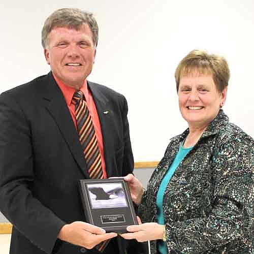Joyce Stacy, right, accepts the Wall of Honor Award from Dr. David Thompson, superintendent.