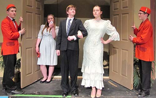 Mr. Osgood (Dylan Reiss) and Mrs. Osgood (Calli McCartan), in foreground, along with their spoiled daughter Dani Osgood (Diana Humble) at left in back, arrive at the Palm Beach Royale's presidential suite to inspect the renovations during a dress rehearsal for the Stewartville High School production of Suite Surrender. They are greeted by the hotel's bellhops, Francis (Brandon Lange), left, and Otis (Nathan Onsgard.)