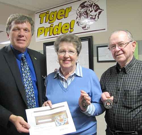 Bob and Marlene King, right, accepted Tiger Tokens from Dr. David Thompson, superintendent of Stewartville schools, left, last week. Thompson thanked the Kings for their willingness to assist the Stewartville School District in a variety of ways.