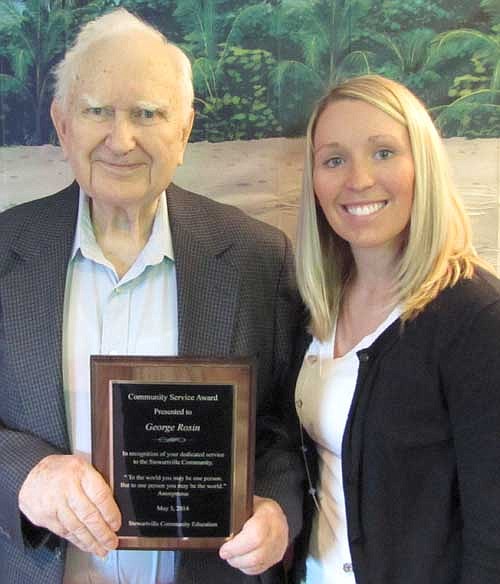 George Rosin accepts the Community Education Community Service Award from Hailey Liffrig.