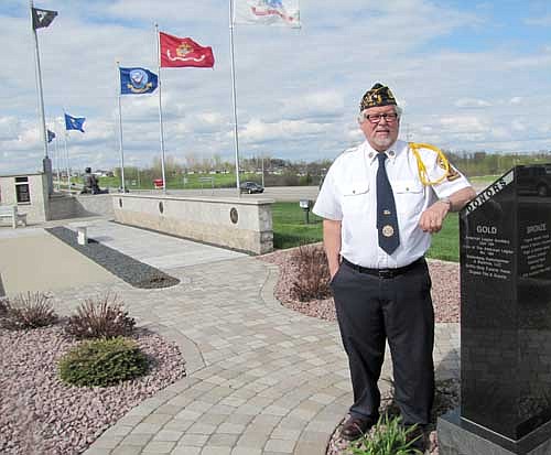 Richard Paulson, commander of the Stewartville American Legion Post 164, standing at the Veterans Memorial near the Legion, is set to host Stewartville's Memorial Day ceremonies at Woodlawn Cemetery on Monday, May 26. A parade will start from near Stewartville Assembly of God Church at 10 a.m., followed by the ceremonies at Woodlawn.