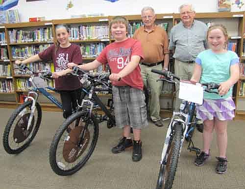 Three students at Central Intermediate School won bicycles in a drawing sponsored by the Stewartville Masonic Lodge and the Olmsted County Deputy Sheriff's Association. Students who read books and write book reports earn the chance to enter their names in the drawing to win a bike. Bicycle winners for the second semester of the 2013-14 school year include, front row, from left, Katelyn McClellan, a fifth grader; Caden King, a fourth grader, and Stormie Mullenbach, a third grader. Len Griffith, left, and George Thompson of the Stewartville Masonic Lodge are standing in back. Griffith, speaking to Central's students at an assembly, told the students that success in life depends on a person's reading skills. "Congratulations to all of you who participate in the reading program,"&#8200;he said. "It's a very important factor to your success in the future." Jan Hagen, a library volunteer for the Stewartville School District, also encouraged the students to read. "Be sure to make use of your library cards this summer," Hagen said. "The best thing you can do is read."