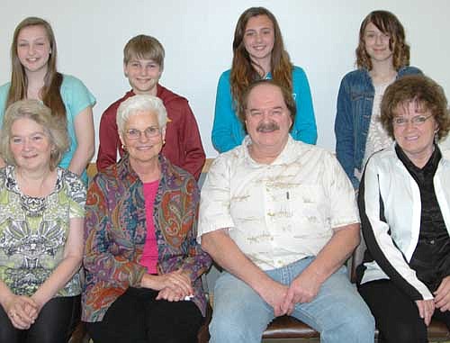 The four sixth graders who were honored for their essays about their favorite older person include, standing from left, Ireland Broadwater, behind Sue Klein, her grandmother; Noah VandeLoo, behind Midge Block, his grandmother; Haylee Weightman, behind Les Thomann, her grandfather; and Savannah Davis, with Ruth Reese, her grandmother.