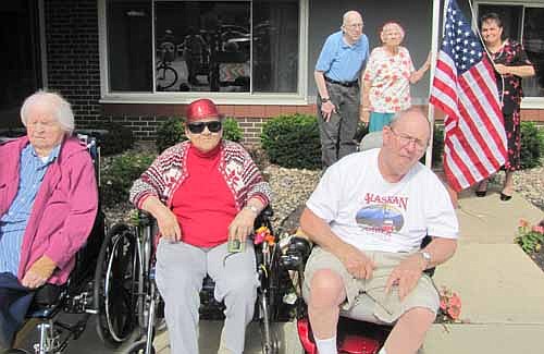 Gloria Nihart of Stewartville, standing at right, has donated a United States flag to the Stewartville Care Center. The flag flew over the U.S Capitol on June 12. U.S. Sen. Amy Klobuchar asked that the flag be flown over the Capitol for Gloria Nihart Ministry in honor of the Stewartville Senior Campus. Clarence and Margaret O'Neil, residents of the Care Center, are standing at left with Nihart. From left, are Care Center residents Bea Raygor, Nihart's mother; Anneliese Laske and David Wendt. 
