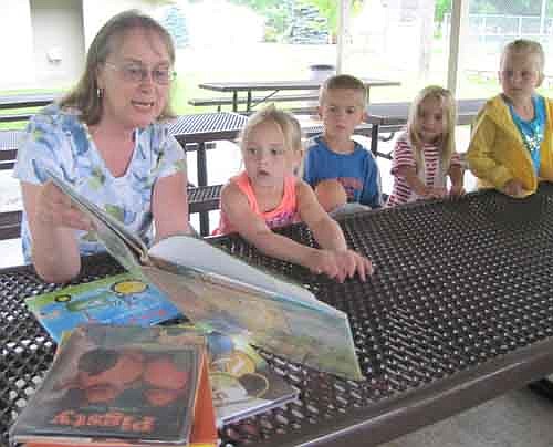 DeeAnn Byrne, a former Stewartville teacher, reads a story to, from left, Natalie Lee, 5, of Grand Meadow; along with Jessie Peterson, 5; Amalia Peterson, 3; and Juliet Zerby-Cox, 5, all of Racine.