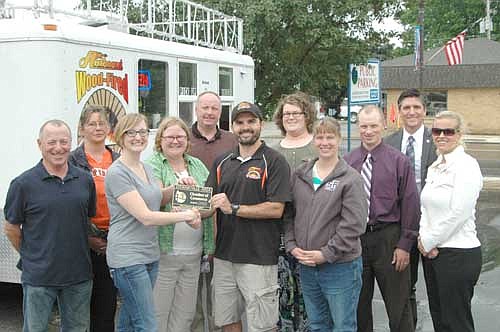 The Stewartville Area Chamber of Commerce welcomed Joe Lawler of Anthony's Wood-Fired Pizza to the local business community with an official Ambassador visit on Tuesday, July 1. Lawler, standing front and center, accepts a Chamber plaque from Melissa Sue Leuning, first vice president of the Chamber, standing third from left, and from Gwen Ravenhorst, Chamber administrator, fourth from left. Other Chamber members include, from left, Jimmie-John King, Deann Stowers, Bill Schimmel Jr., Emily Christie, Becky Monty, Andrew Mai, Jarett Jones and Beth Schmidt.