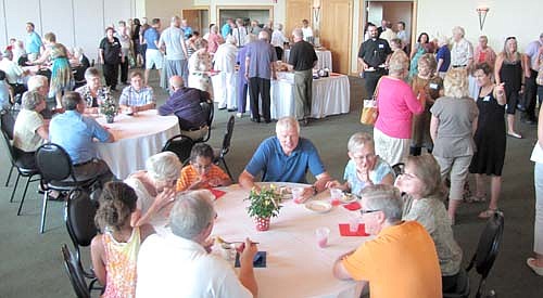 Hundreds of Stewartville and area residents crowded into the banquet hall at the Riverview Greens Golf Club to attend an open house to celebrate the 100th anniversary of the Griffin-Gray Funeral Home on Sunday, July 6. Larry Gray of Griffin-Gray estimated that close to 400 people attended the event. "It was steady all three hours," he said. "We had food for 500 people, and there was very little left."