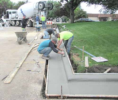 Workers from Birch Construction of Stewartville put in a new curb at the City Hall parking lot last week. Barb Neubauer, city finance director, said that the curb is part of a parking lot project that included an island, sod and trees that will cost about $10,000.