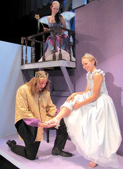 The prince (Dave Stepan) discovers that the shoe fits Cinderella (Kallie Quinn) as the fairy godmother (Lee Menz) looks on from above during a dress rehearsal for the Stewartville Community Theatre production of "Cinderella."