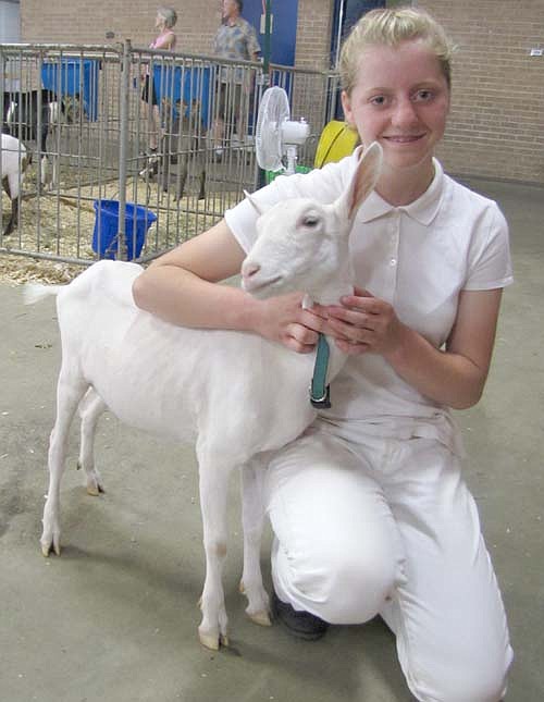 Abigayle Wilson, 15, a member of the High Forest Chippewa Champions 4-H Club, poses with Sussie, her grand champion dairy doe. 