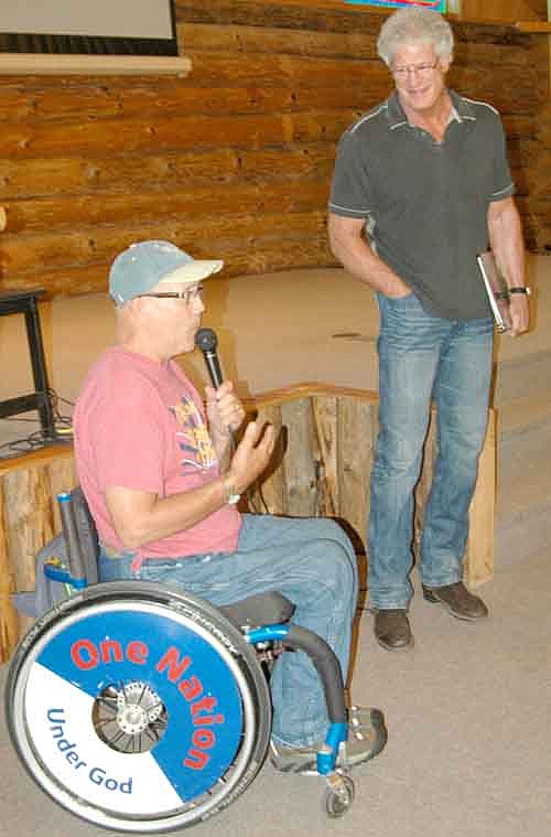 Mark Mullaney, a former defensive end for the Minnesota Vikings, standing, was a featured speaker at Ironwood Springs Christian Ranch on Saturday, July 26. Bob Bardwell, director of Ironwood Springs, is at left.