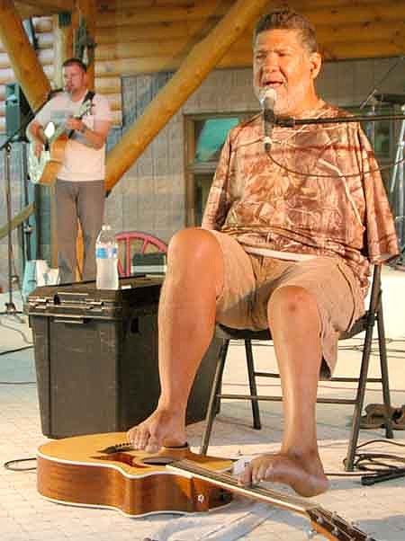 Tony Melendez, born without arms, played the guitar with his feet and sang to a large audience at the Miracles Happen Festival at Ironwood Spring Christian Ranch on Saturday, July 26. "Once in awhile I look in the mirror and forget that I am armless," Melendez said.