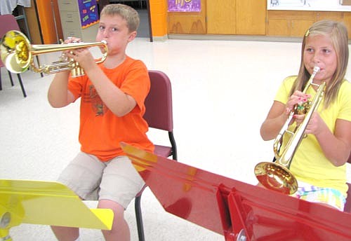 Connor Myhrvold, left, and Ella Quam, fifth graders at Central Intermediate School, practiced playing the trumpet as members of the school's Beginners Band last week. Carol Bressel, director, worked with musicians who play brass and percussion on Wednesday, Aug. 20 and with students who play woodwinds on Thursday,  Aug. 21.