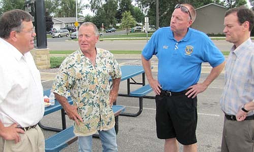 Jeff Johnson, Republican candidate for governor, far right, and running mate Bill Kuisle, a Stewartville area farmer, far left, meet with Stewartville Mayor Jimmie-John King, second from left, and City Administrator Bill Schimmel Jr., second from right, at Stewart-ville's The Dog Days of Summer celebration last Thursday, Aug. 21.