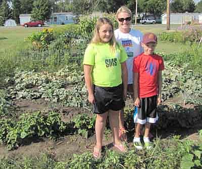 Mandi Derr and her children, Mackenzie Engle, 12, and Cooper Engle, 9, visited their plot at the Stewartville Community Garden about two weeks ago to check on the status of their pumpkins, cantaloupe, green beans, peppers, onions and cucumbers. "We come out twice a week to water and pick the vegetables," Derr said. "It's low maintenance."