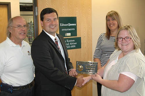 The Stewartville Area Chamber of Commerce welcomed Troy Knutson, the new local financial advisor for Edward Jones Investments, to the local business community with a recent official ambassador visit. Gwen Ravenhorst, Chamber administrator, far right, presents Knutson with a Chamber plaque. Charlie Brown, Chamber member, is at far left. Becky Burdick, branch office administrator of Edward Jones Investments, stands second from right.