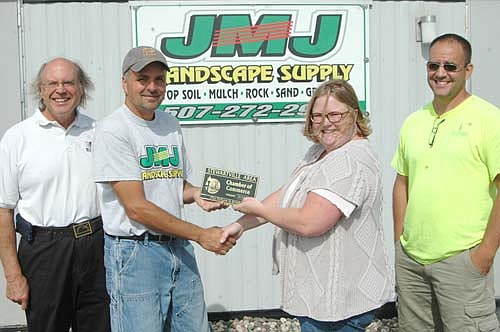 The Stewartville Area Chamber of Commerce welcomed JMJ Landscape Supply to the local business community with a recent official ambassador visit. Gwen Ravenhorst, Chamber administrator, second from right, presents a Chamber plaque to Joe Jones, owner of JMJ Landscape Supply. Charlie Brown, Chamber member, is at left. Ryan Davis of Davis WoodScapes, a customer of JMJ Landscape Supply, is at right.