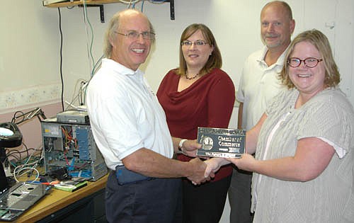 The Stewartville Area Chamber of Commerce welcomed PC Applications to the local business community with a recent official ambassador visit. Gwen Ravenhorst, Chamber administrator, right, presents a Chamber plaque to Charlie Brown, owner of PC Applications, as employees Melanie McCarty and Dave Gleason look on.