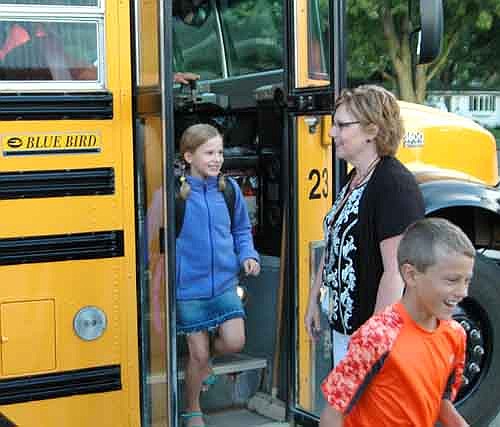 Students returned to Stewartville schools last Tuesday morning, Sept. 2. Clockwise from above left, Janna Sistad, a paraprofessional, welcomes third graders Karter Wicklund, foreground, and Taylor Klement, stepping off the bus.