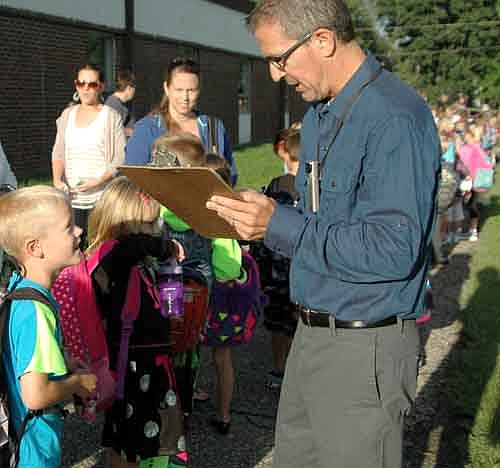 Students returned to Stewartville schools last Tuesday morning, Sept. 2. Here, Rick VandeLoo, a second-grade teacher, takes information from student Matthew Watters.