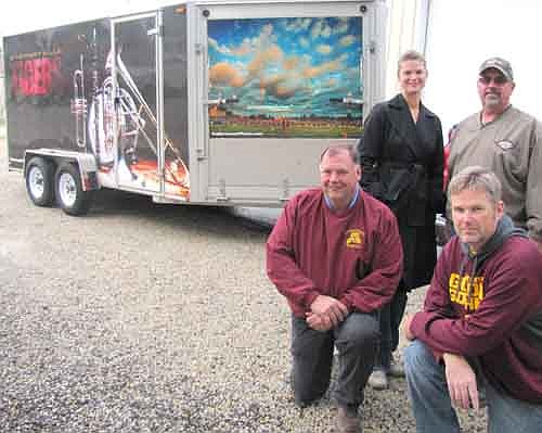  Scott Gulbranson of GulbransonPHOTO.com, kneeling at right, took the photos that adorn the trailer that carries equipment for the Stewartville High School football and band programs. Those who appreciate Gulbranson's work include Rick Gehling of the Stewartville Football Boosters Club, kneeling at left; Jessica Honsey, SHS band director, standing left, and Curt Grisim of Grisim School Bus, Inc.