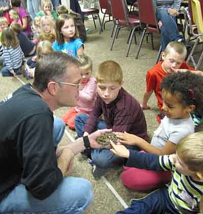 Travis Meyer, a naturalist with the Quarry Hill Nature Center, brought his animal friends to St. John's Lutheran Church last week. Dozens of Wee Care children got an up-close look at a frog, a toad and a salamander.