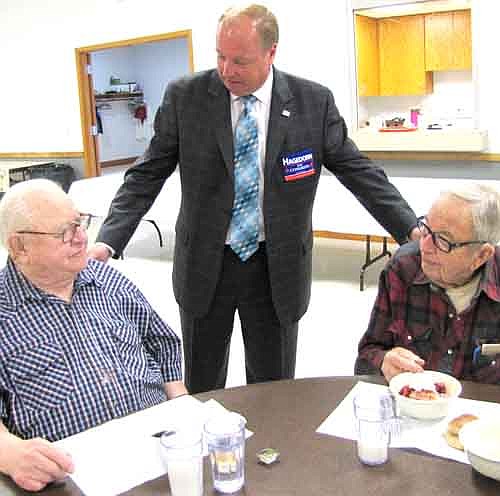 Jim Hagedorn, center, running to unseat Tim Walz as the U.S. representative for Minnesota's First Congressional District, says hello to Fahy Lowrie of Stewartville, left, and Maurice Sinn of rural Stewartville at the Center for Active Adults on Friday, Oct. 10.