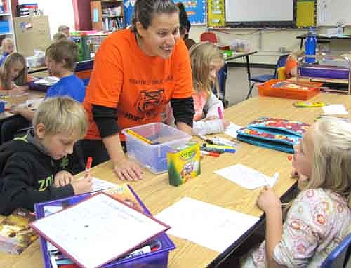 Courtney Fakler, a school counselor, above, talks to fourth graders Tyler Grim, left, and Haley Hyke, far right, at Central Intermediate School during an anti-bullying lesson last Wednesday, Oct. 22.