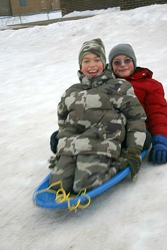 HERE WE GO -- Justin Diekmann, 8, of Stewartville, in the foreground, and his brother Dillon, also 8, enjoyed sledding down the hill near Bonner Elementary School on Thursday afternoon, Jan. 10. 