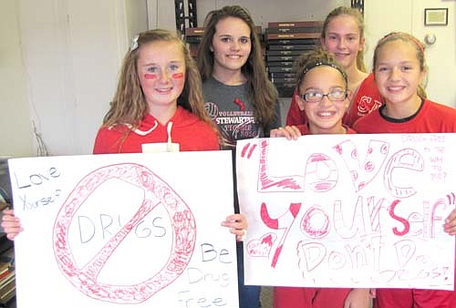 Dawn Miller's health students at Stewartville Middle School celebrated National Red Ribbon Week Oct. 23-31 by running to and stopping at a number of downtown businesses to hand out ribbons and display posters declaring "Love Yourself, Be Drug-Free"&#8200;last week. A few of the seventh graders include, from left, Alyssa Dwire, Sierra Robertson, Kylee Mullenbach, Gabbie Schei and Gracie Waltman.