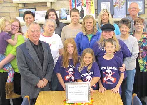 Vicki Snyder, outreach coordinator for the Epilepsy Foundation of Southern Minnesota, standing at far right, presented Mayor Jimmie-John King, at left in the front row, with a certificate declaring Stewartville a Seizure-Smart community on Saturday, Nov. 1.  Others from the community who support the cause are also pictured.