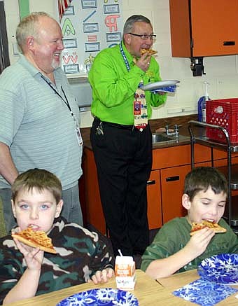 102.5 The Fox Radio delivered pizza to Kim Whiting's second-grade students at Bonner Elementary School on Wednesday, Jan. 9.  The radio station named Whiting its Teacher of the Month after Tanner Olson, one of Whiting's students, submitted a letter describing why Whiting is such a good teacher. Here, Whiting, standing at left, smiles as Bonner Principal Dave Nystuen, standing at right, and students Russell Lannier and Matthew Kuchera enjoy their pizza. 