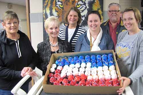 Members of the Stewartville American Legion Post 164 and Auxiliary Unit 164 celebrated American Education Week (Nov. 16-22) last week by delivering cupcakes to educators at Stewartville High School and Middle School, above, along with the staffs at Bonner Elementary School and Central Intermediate School. Peggy Paulson of the Legion Auxiliary, far left, and Richard Paulson of the Legion, second from right in back, delivered the cupcakes to educators, from left, Mary Regenscheid, Sherry Thompson, Katie Young and Kaysie Manion