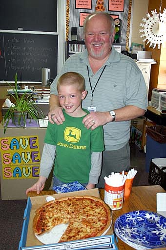 102.5 The Fox Radio delivered pizza to Kim Whiting's second-grade students at Bonner Elementary School on Wednesday, Jan. 9.  The radio station named Whiting its Teacher of the Month after Tanner Olson, one of Whiting's students, submitted a letter describing why Whiting is such a good teacher. Whiting stands with Tanner Olson, who nominated his teacher for the award. 