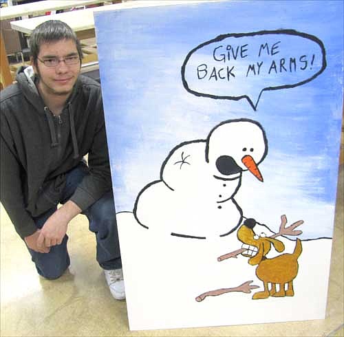 Dalton Barrie, 18, a senior at SHS, displays his humorous Christmas card. Speaking about the Art Gala and Silent Auction, he said, "It's a great way to make money and get art out there."