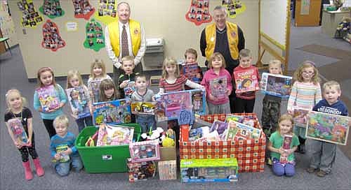 Bill Schimmel Jr., left, and Dave Nystuen of the Stewartville Lions Club, standing in back, visited St. John's Wee Care on Thursday, Dec. 4 to collect gifts donated by Wee Care families to the annual Lions Club Christmas Anonymous gift and fund drive. Each year, the Lions deliver the gifts to a distribution center in Rochester, where the presents are made available to Olmsted County children who otherwise might not get a Christmas gift.