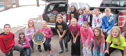 Students at Central Intermediate School have donated many gifts to the Stewartville Lions Club's 2014 Christmas Anonymous gift and fund drive. Lions Club members packed the gifts into two vehicles for shipment to a distribution site in Rochester last week. Students posing with the gifts include, front row, from left, Brandon McCrady, Lyndsie Weber, Claire Olson, Lydia Fryer, Kadi Spratte, Bryttin Henderson, Kinsey Giordano, Meghan Urban and Megan Myhrvold. Back row, from left, Kylee Hartson, Alayna Sickle, Bailey Buckmeier, Titan Klunder and Landon DeCook. 