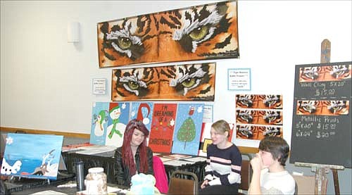 Art students from Stewartville High School greeted bidders at one of the tables displaying SHS artwork during Winterfest activities at the Stewartville Civic Center on Saturday, Dec. 6. Proceeds from the Art Gala and Auction will pay for an art scholarship for a local student.