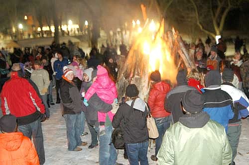 Residents stand near the bonfire at the Stewartville Area Chamber of Commerce's Winterfest celebration at Florence Park on Saturday evening, Dec. 6.