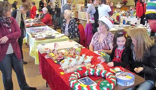 Tammy Fritz, left, talks with Myrna Welter, leader of the Stewartville American Legion Junior Auxiliary, at Santa's Workshop & Bakery at the Stewartville American Legion on Saturday, Dec. 13. Crafters at the event offered American doll clothes, burlap wreaths and decorations, soaps, lotions, jewelry and beaded items, scarves, lighted decorations, frames, wooden crafts and more.