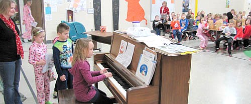 With Lara Smoley, music teacher, looking on at left, students at Bonner Elementary School played Christmas music for the student body on Tuesday, Dec. 23, the last day of school before Christmas vacation.