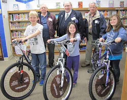 Three students from Central Intermediate School have won bicycles courtesy of the Stewartville Masonic Lodge and the Olmsted County Deputy Sheriffs Association. Students who received the bicycles at an all-school assembly on Monday, Dec. 22 include, in front, from left, Henry Gray, a fourth grader; Bella Vasoli, a third grader; and Brenna Yeadon, a fifth grader. In back, from left, are George Thompson, William Hubbard and Leonard Griffith, all past masters of the Stewartville Masonic Lodge. To be eligible to win a bicycle, a student must read a  book, then enter his or her name for each book read in a drawing held each December and May. Hubbard spoke briefly at the assembly, saying that the Masons give away the bikes as a way to motivate young students to read. "We really would like you to read," he told the students.